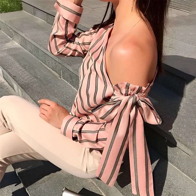 a woman sitting on steps with a cell phone in her hand