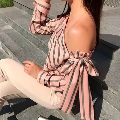 a woman sitting on steps with a cell phone in her hand