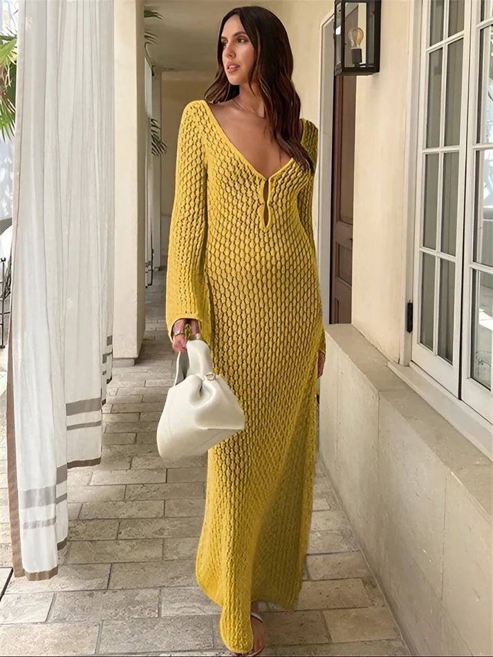 a woman in a yellow dress is holding a white purse