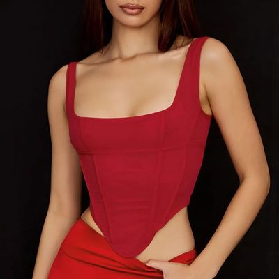 a woman in a red dress posing for a picture