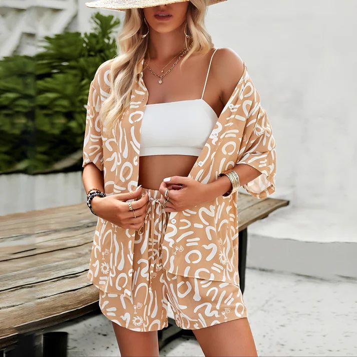 a woman wearing a tan and white top and matching shorts