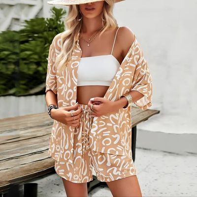 a woman wearing a tan and white top and matching shorts