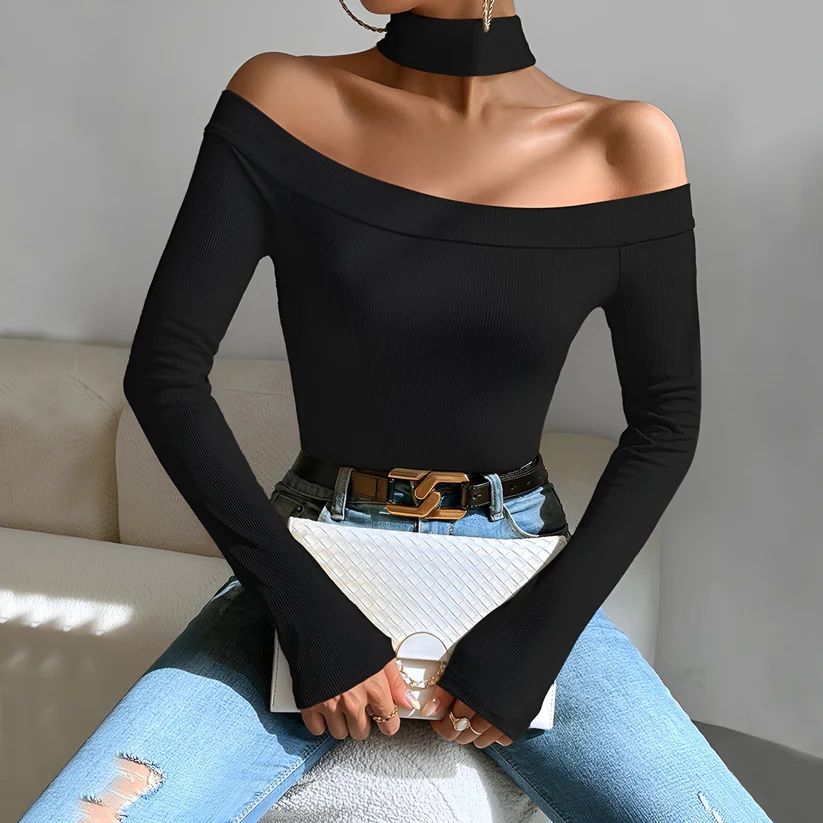 a woman sitting on a couch wearing a black top