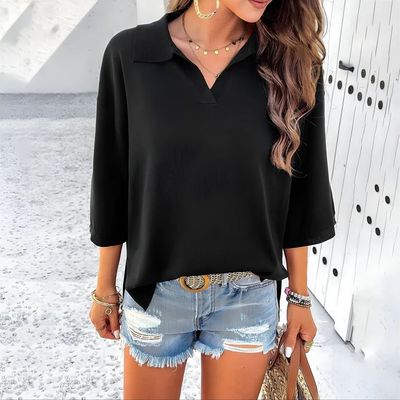 a woman wearing shorts and a black top