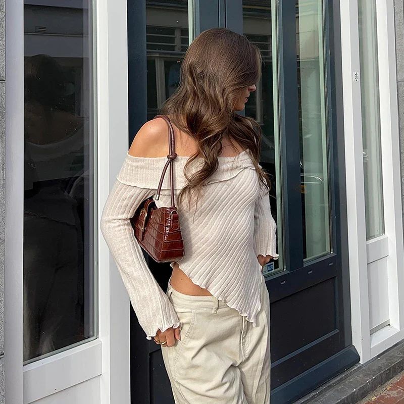 a woman standing in front of a door with her hands on her hips