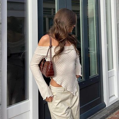 a woman standing in front of a door with her hands on her hips