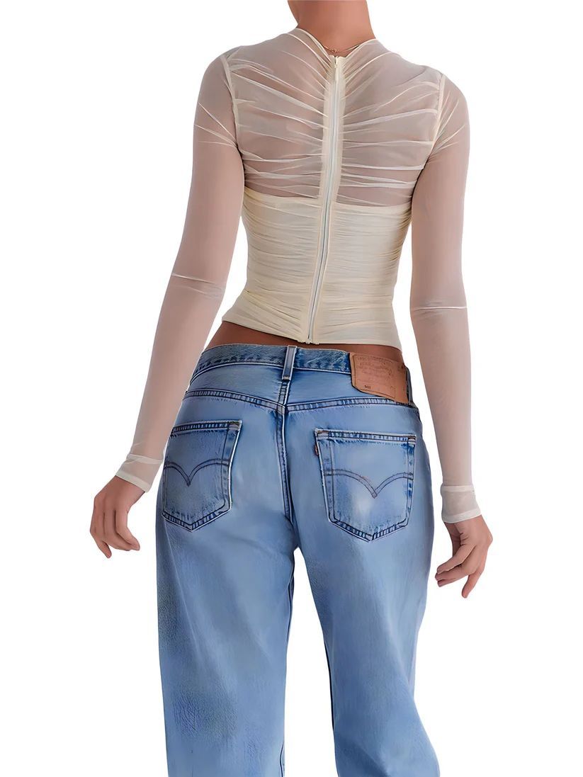 a woman wearing a white top and jeans