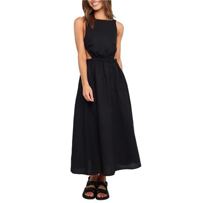 a woman wearing a black dress and sandals