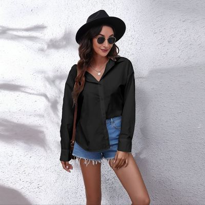 a woman wearing a black shirt and denim shorts