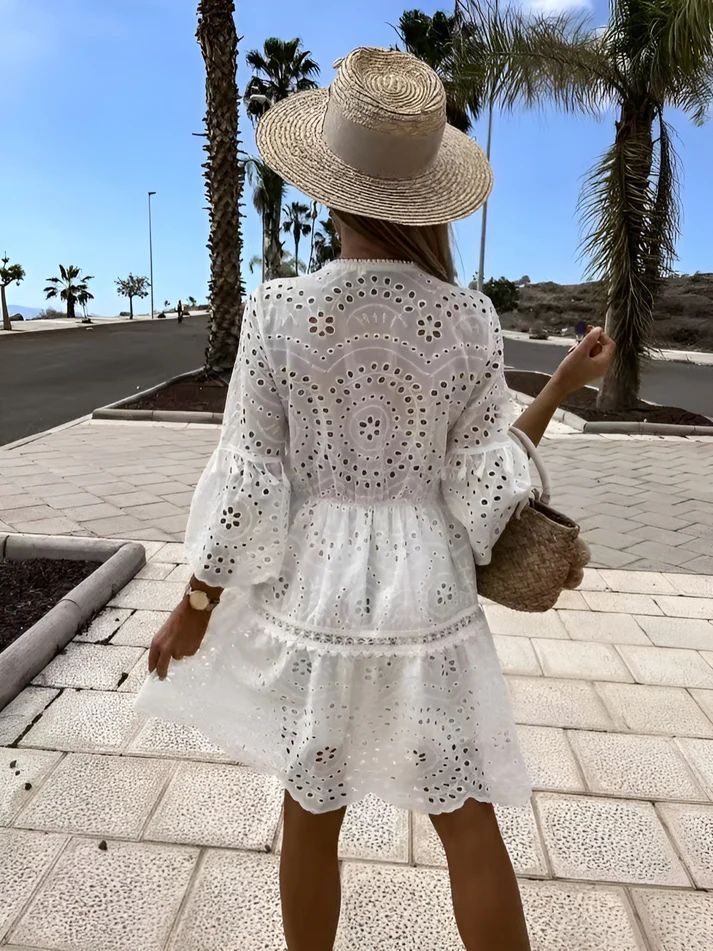 a woman wearing a white dress and a straw hat