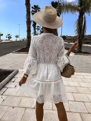 a woman wearing a white dress and a straw hat
