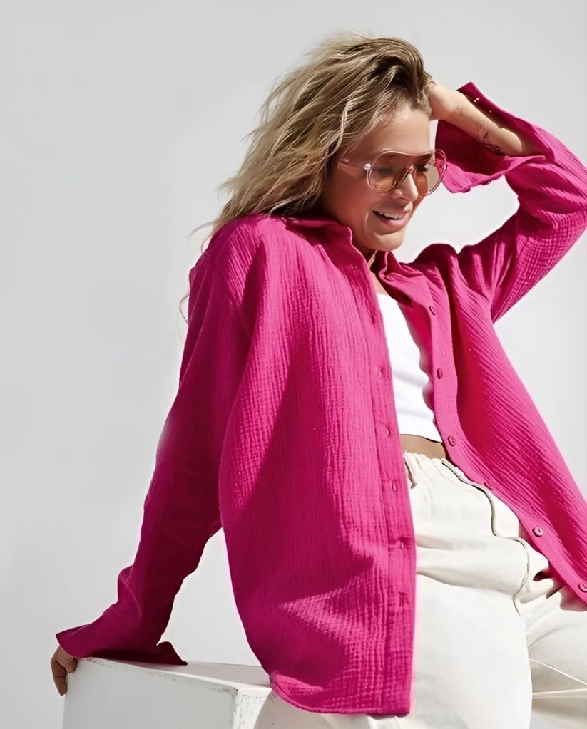 a woman in a pink shirt and white pants