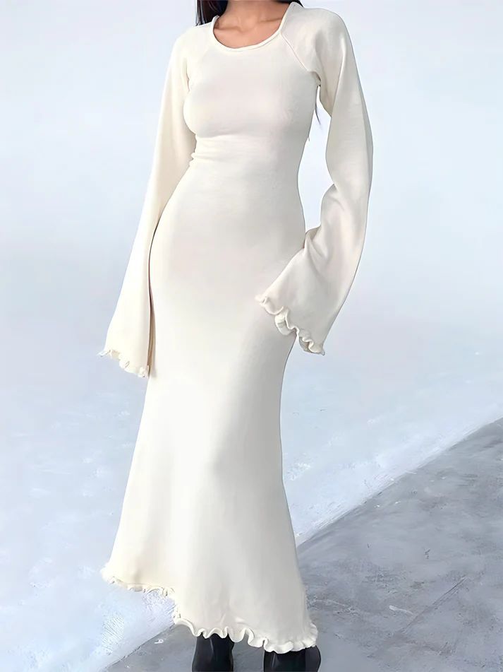 a woman in a white dress posing for a picture