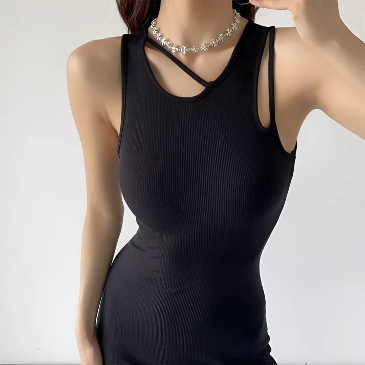 a woman taking a picture of herself in a black dress