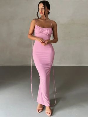 a woman in a pink dress posing for a picture