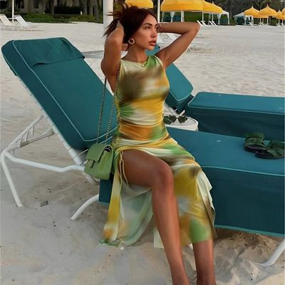 a woman sitting on a chair on the beach