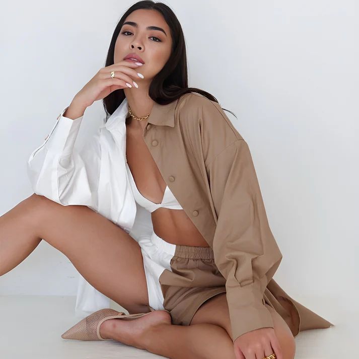 a woman sitting on the floor with her legs crossed
