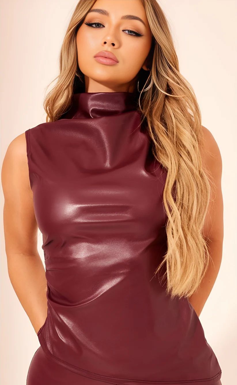 a woman wearing a maroon leather dress