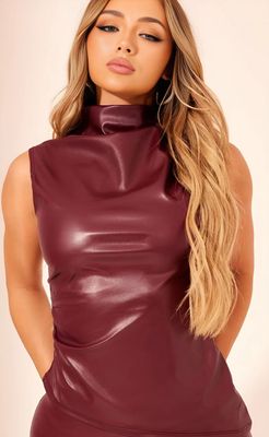 a woman wearing a maroon leather dress