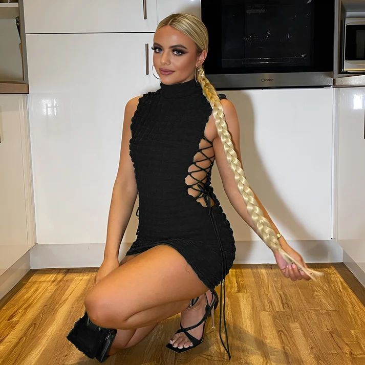 a woman in a black dress with a braid in her hair