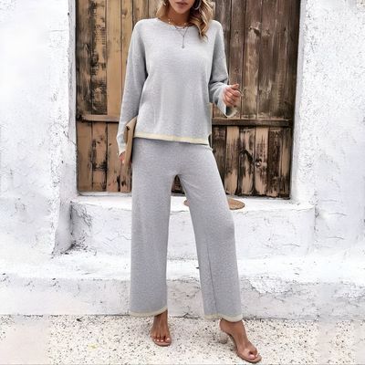 a woman wearing a gray sweater and pants