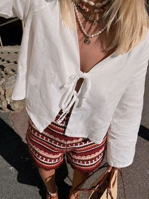 a woman wearing shorts and a white shirt