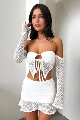 a woman in a white dress posing for a picture