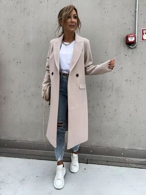 a woman standing in front of a wall
