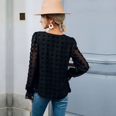 a woman wearing a hat and a black top