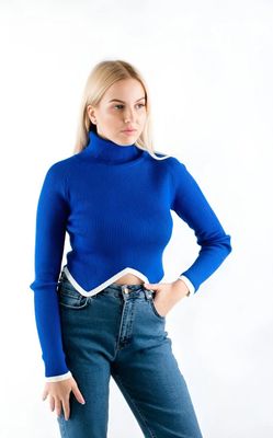 a woman wearing a blue sweater and jeans