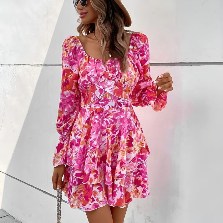 a woman in a pink floral dress and hat