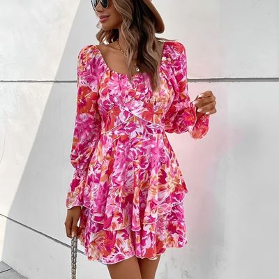 a woman in a pink floral dress and hat
