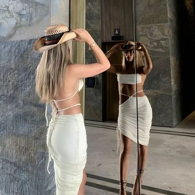 a woman standing in front of a mirror