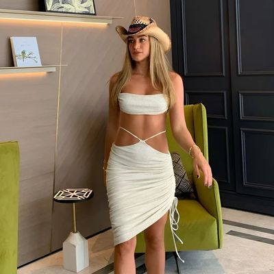 a woman in a white dress and a cowboy hat