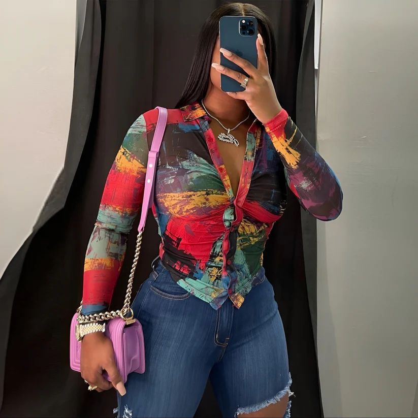 a woman taking a picture of herself in a mirror