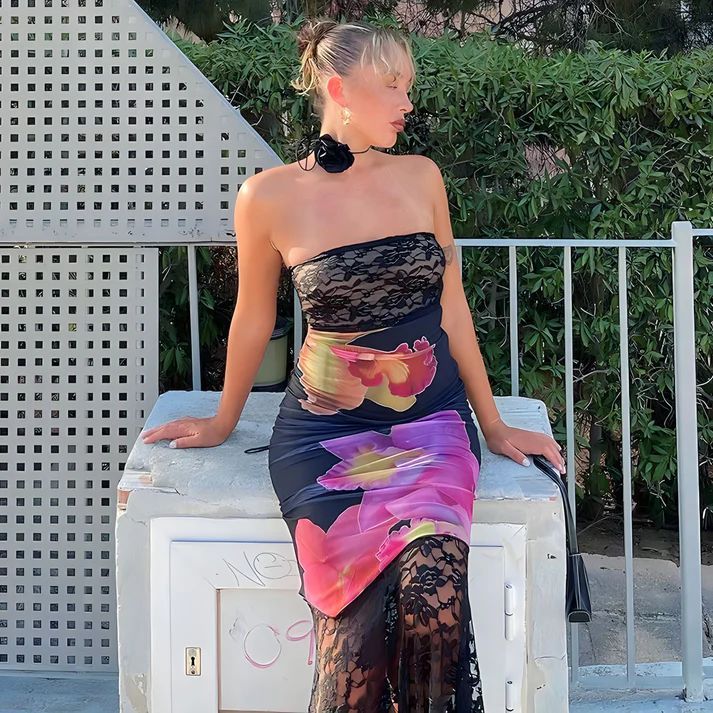 a woman in a dress sitting on a bench