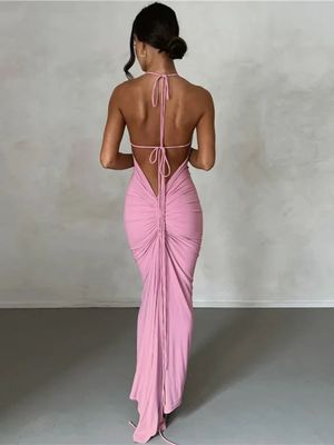 a woman in a pink dress with a backless top