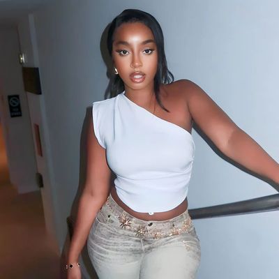a black woman in a white top and jeans