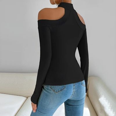 a woman wearing a black top and jeans