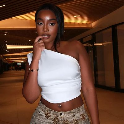 a woman in a white top posing for a picture