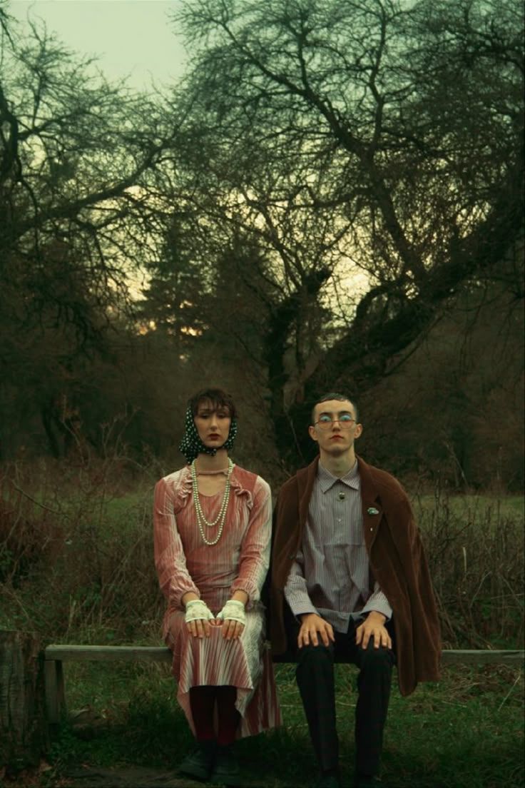 a man and a woman sitting on a bench