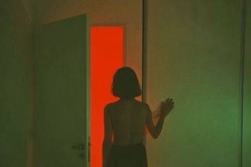 a woman standing in front of a red door