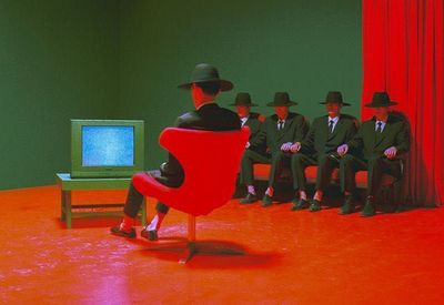 a group of men sitting in front of a tv