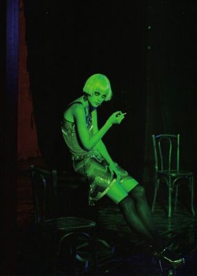 a woman sitting on a chair with a cell phone in her hand