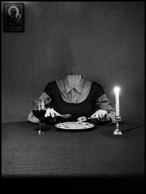 a woman sitting at a table with a plate of food