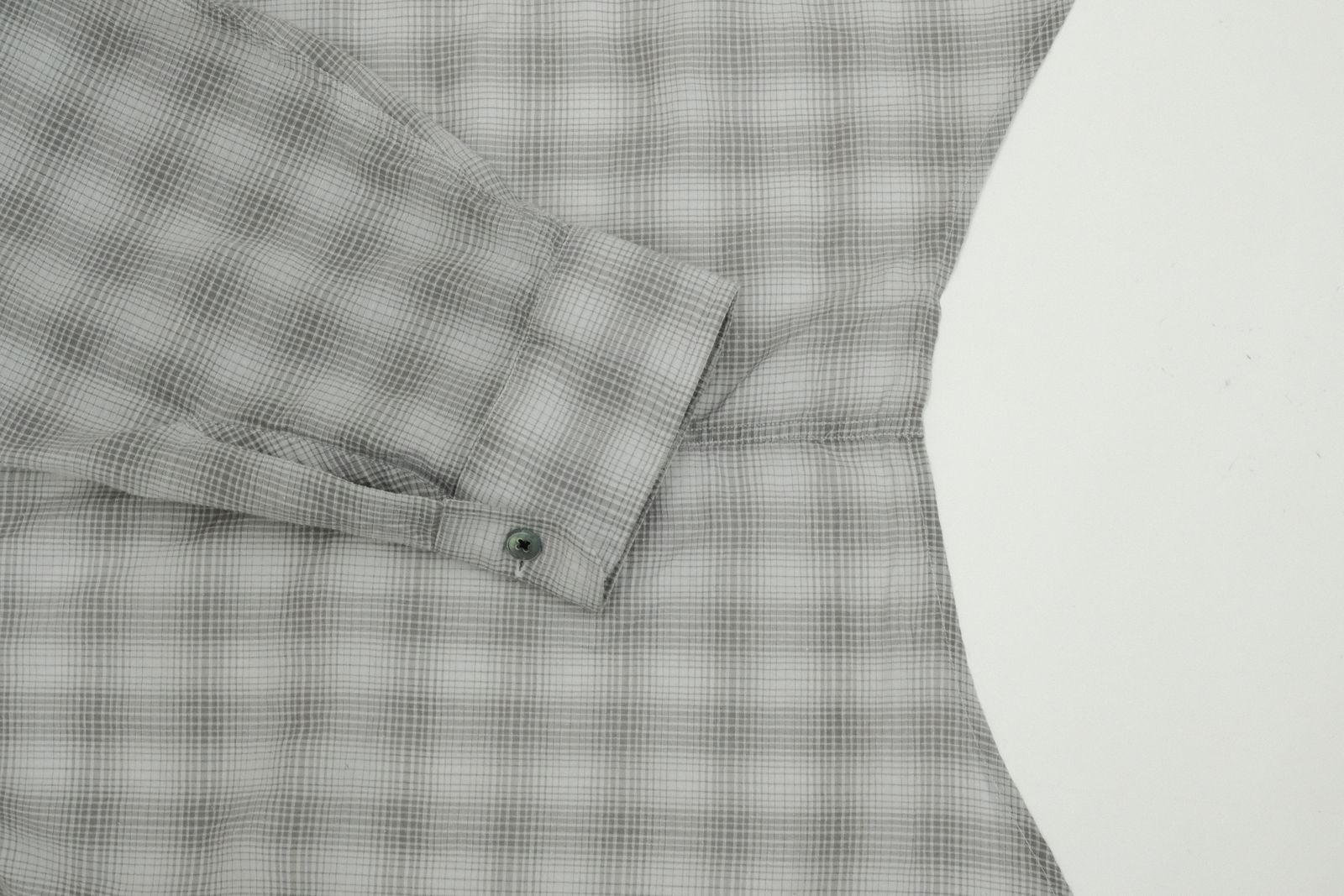 a close up of a shirt on a white surface