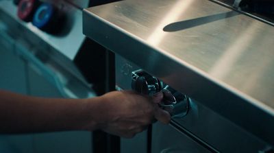 a person opening a drawer in a kitchen