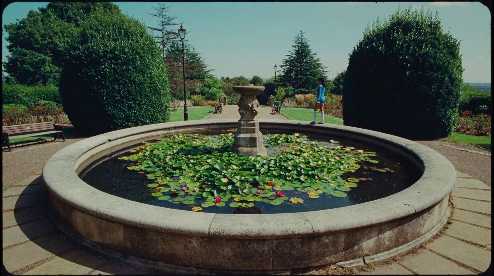 a fountain with lily pads in a park