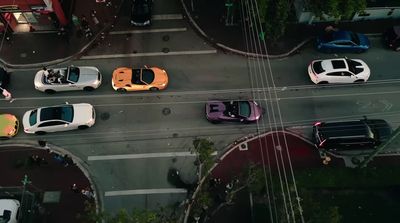 a group of cars that are sitting in the street