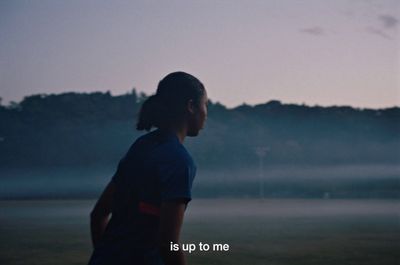 a person standing in a field with a frisbee